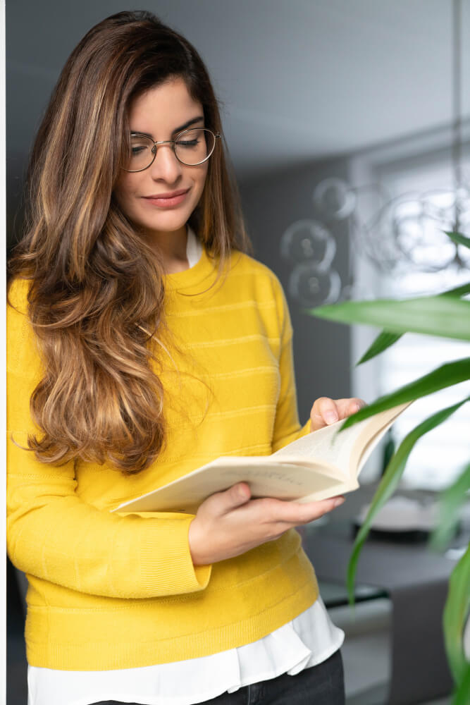 girl standing and reading book